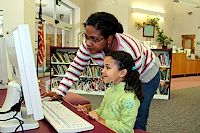 teacher and child on computer